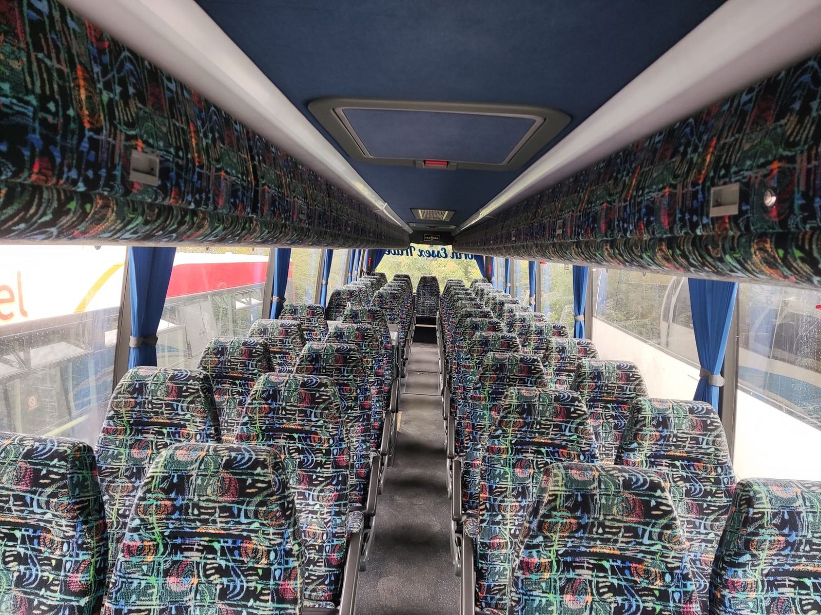 Comfortable patterned seats inside a North Essex Travel coach